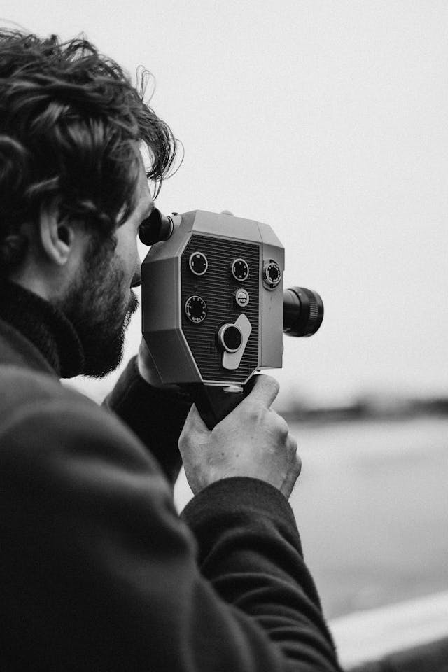 Boy with 8mm film camera (photo by CottonBro Studio)